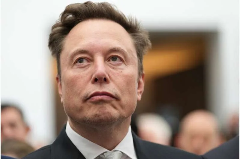 Elon Musk listens as Donald Trump speaks during an event at the U.S. Institute of Peace.