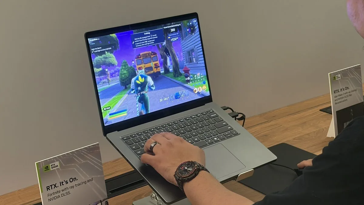 A user plays a game on a laptop at an event display table.