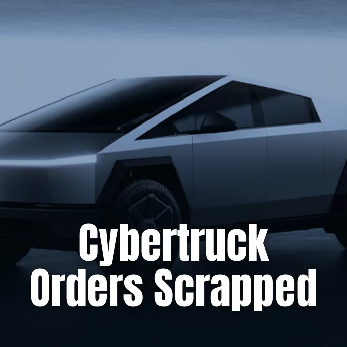 A stainless steel Tesla Cybertruck viewed closely from the front three-quarters against a muted sky background.