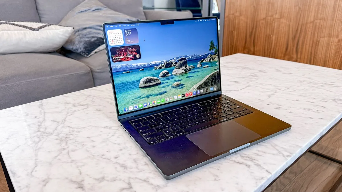 The current MacBook Pro rests on a surface showcasing its keyboard and screen.