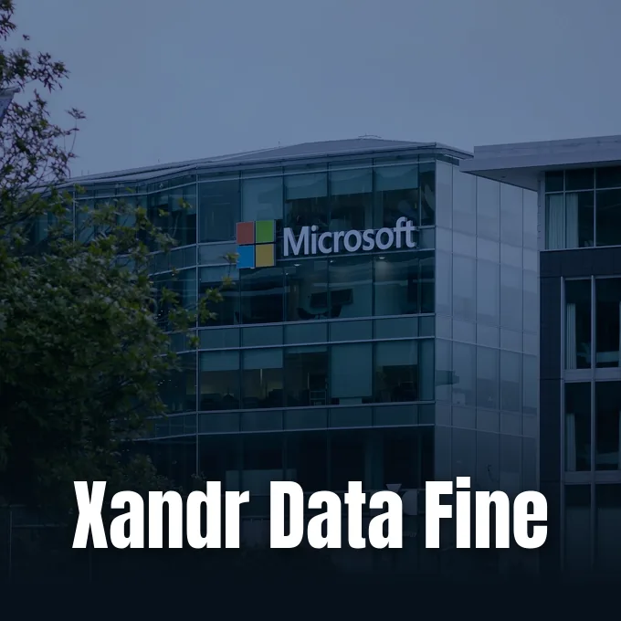 A modern glass office building displaying the Microsoft logo under an overcast sky.