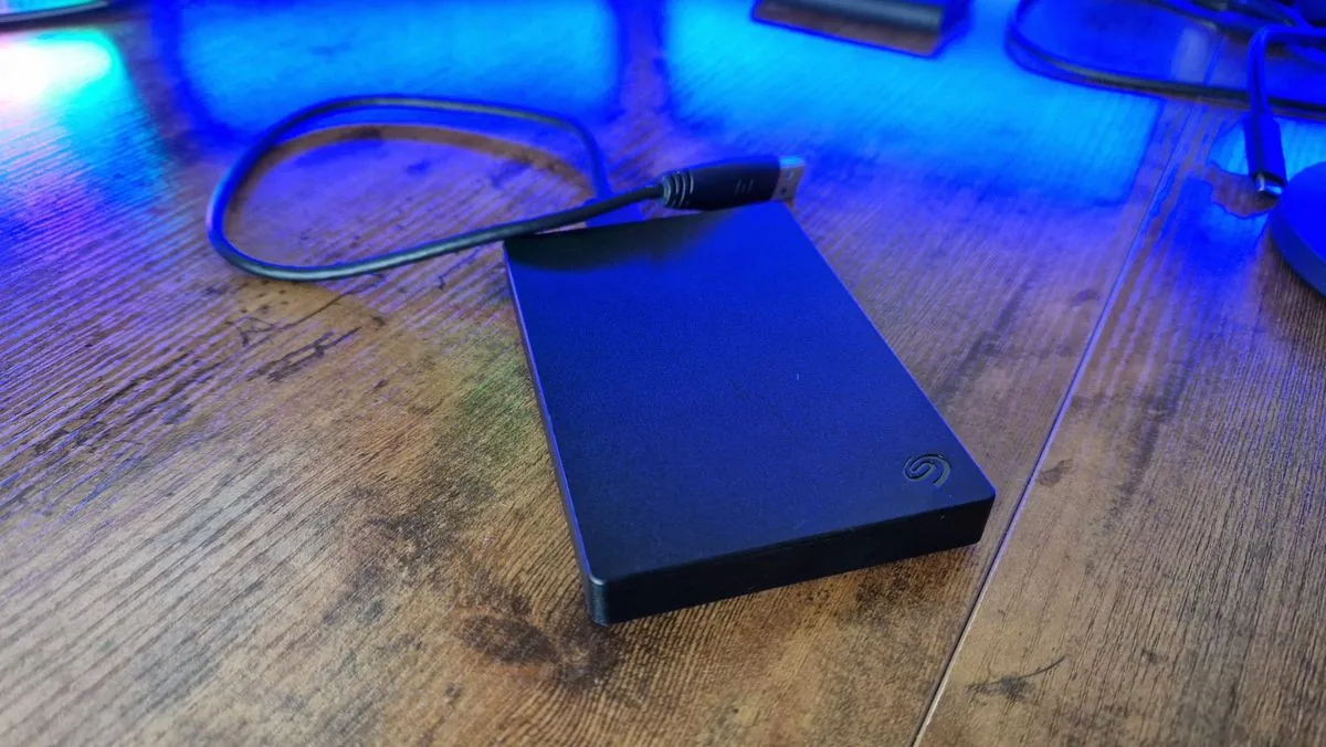 Seagate portable hard drive on a gaming desk.