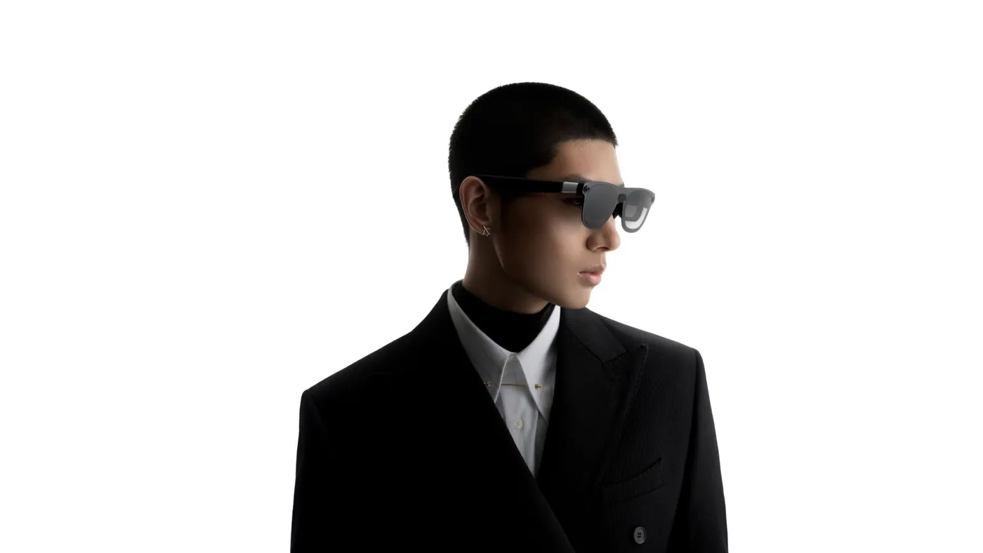 A person wearing XREAL Aura smart glasses during a demonstration