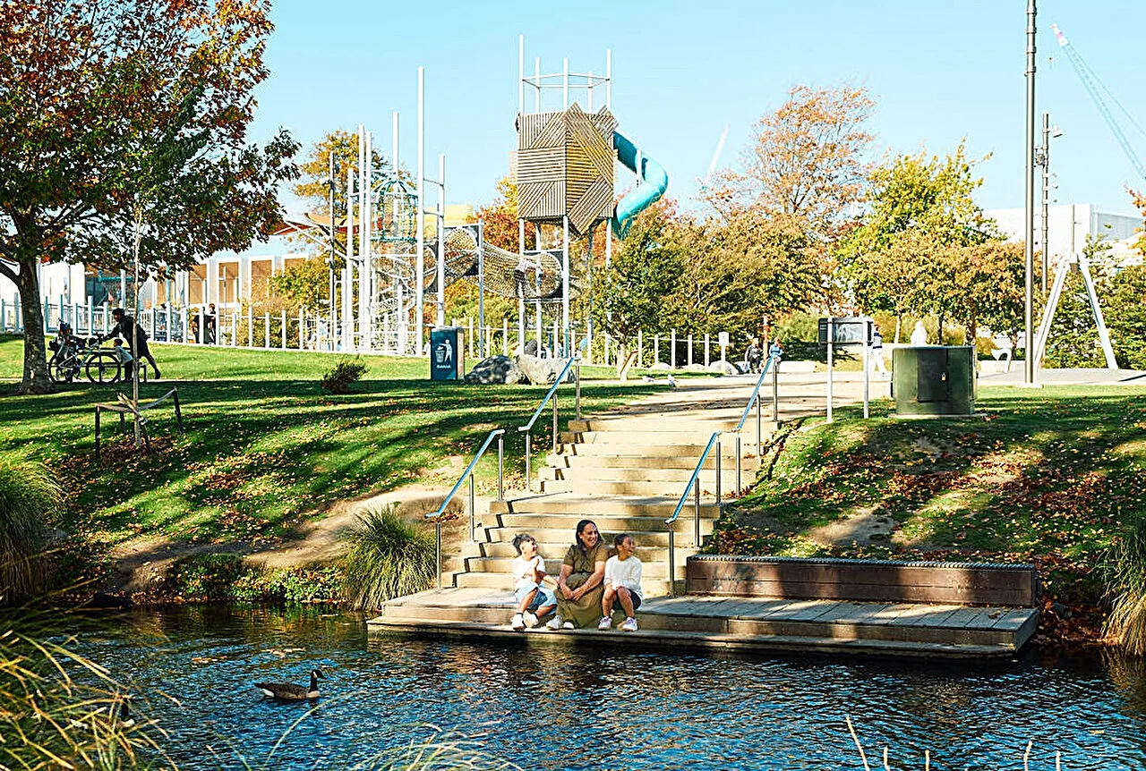 An open public green space and river corridor in an urban area.