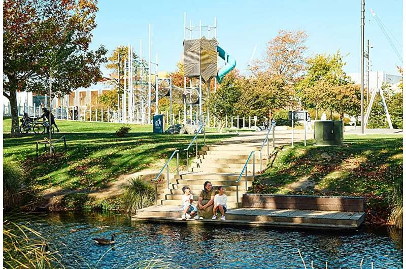 Families gathered near the Ōtākaro Avon River and Margaret Mahy Family Playground in New Zealand connected to youth mental health studies.